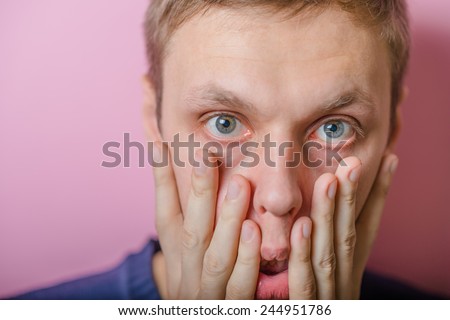 Blond young man shocked tired. Gesture. Close portrait. Isolated yellow background. photo