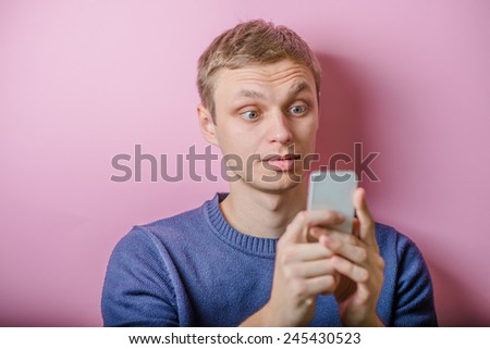 handsome  man looking at phone stun portrait