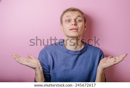 Portrait of casual young man gesturing do not know sign