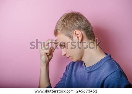 young man. Gesture. Man thinks, looking away.