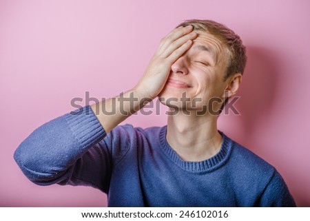 Worried or ashamed man covering his face with hand