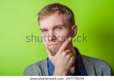 Young man  chin resting on his hands  with an intent sincere expression