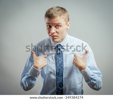 Closeup portrait of angry, unhappy, annoyed young man, getting mad, asking question: you talking to me, you mean me? Isolated on white background. Negative human emotion, facial expression, feelings