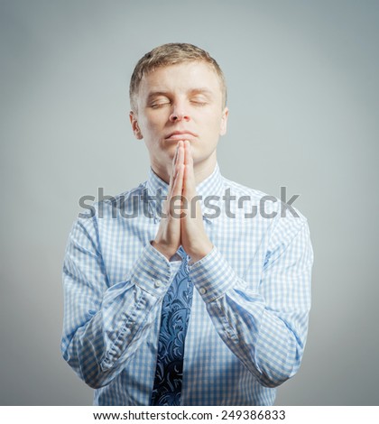 Closeup portrait of young man, open mouth, praying looking up hoping for best asking for forgiveness, miracle isolated white background. Human emotions, facial expressions, feelings, reaction