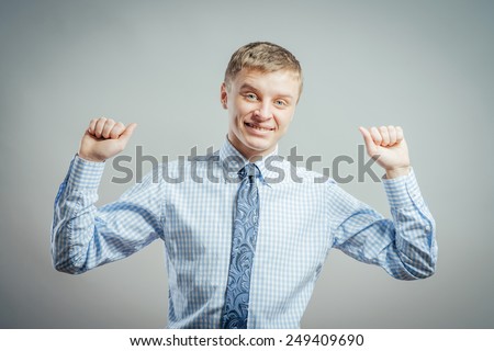 Happy young man wearing checked shirt and jeans in winning pose isolated