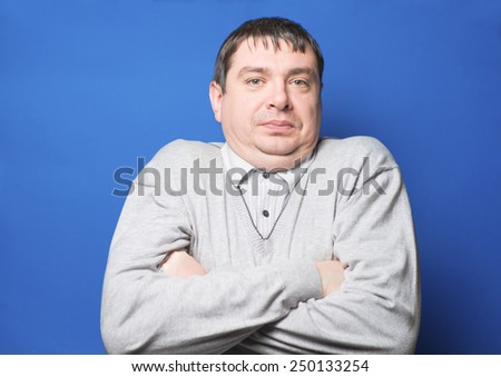 Portrait of young man . Handsome young  male model standing with his arms crossed looking at camera.