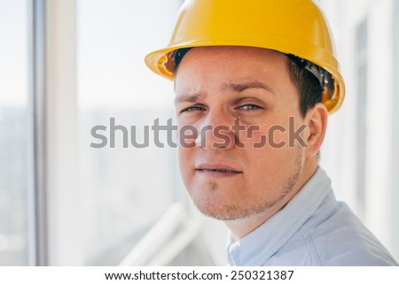 Male contractor or civil engineer looking at the building project on progress
