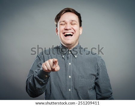 Smart young mansmile and pointing at you