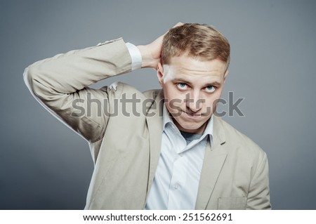 Closeup portrait of angry, frustrated man, hand on head. Negative human emotions and facial expressions
