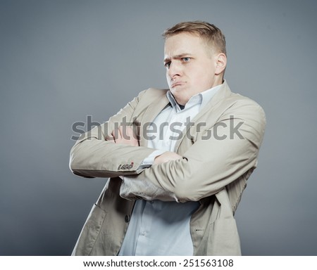 Annoyed male crosses his arms in disappointment