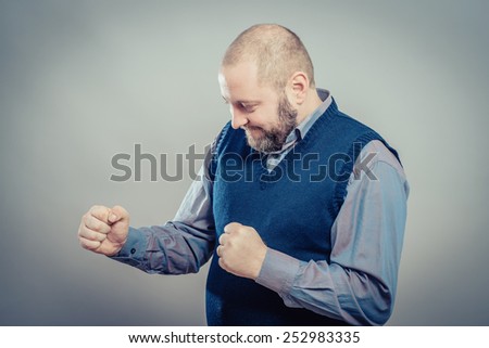 Closeup portrait happy , business man winning, fists pumped celebrating success isolated grey wall background. Positive human emotion, facial expression. Life perception, achievement