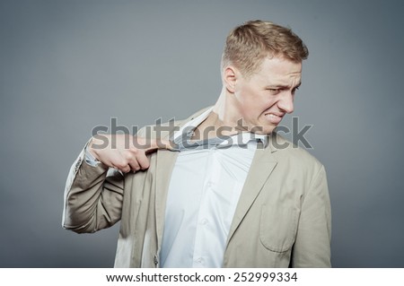 Closeup portrait of young man opening shirt to vent,it\'s hot. Negative emotion, facial expression, feeling