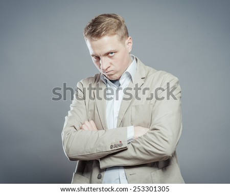 Closeup portrait of a very sad, depressed, alone, disappointed man resting his face on hands, side profile isolated on graybackground