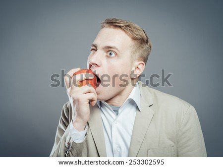 hungry man eating a fresh apple.