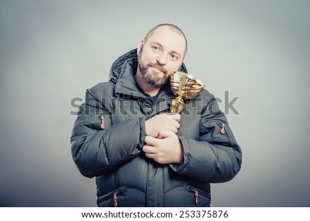 Character businessman winner holds cup