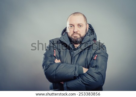 Fashion portrait of young handsome man in black  winter jacket. Glamour male model