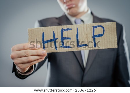 Man holding paper with help text