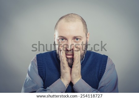 a young man upset with hands on face