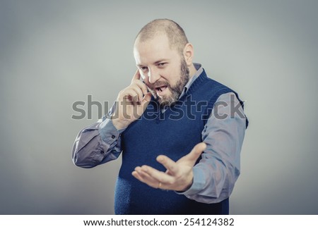 young man with wide open mouth talking on cell phone