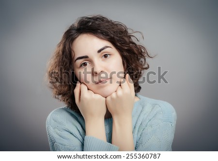 Beautiful sad casual lady isolated on gray background
