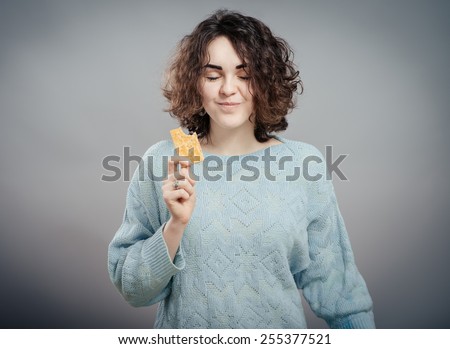 Cookie woman eating  cookies . Cute young  caucasian woman smiling.