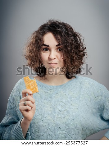 Cookie woman eating  cookies . Cute young  caucasian woman smiling.