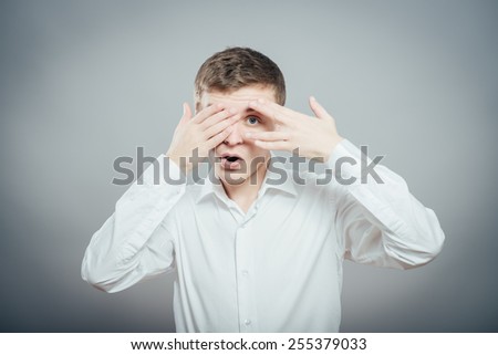 Closeup of young man hiding face whit hands