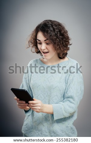 Elegant young businesswoman using tablet , looking at screen