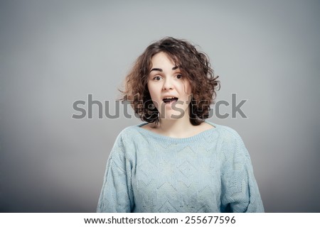 Closeup portrait  woman talking with sound coming out of her open mouth isolated grey wall background.