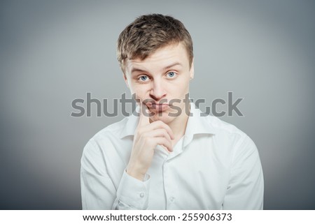 young businessman scratching his head, hard decision, studio shoot