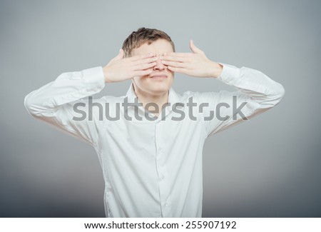 A man covering his eyes with his hands