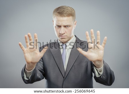 Afraid man in defense attitude gesturing stop with hands
