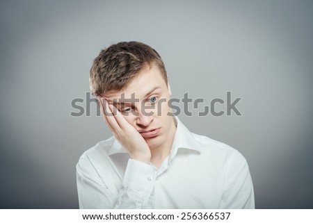Closeup portrait of a groggy upset worried sad, depressed, tired business man with a headache and very stressed hand in hair, isolated , Negative human emotion facial expression