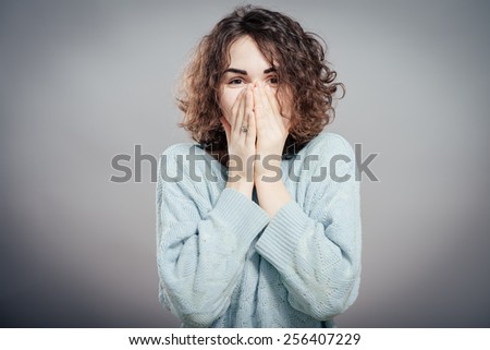 Young woman shocked. Attractive female student in a sweater