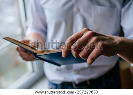 Man reading. Book in his hands.