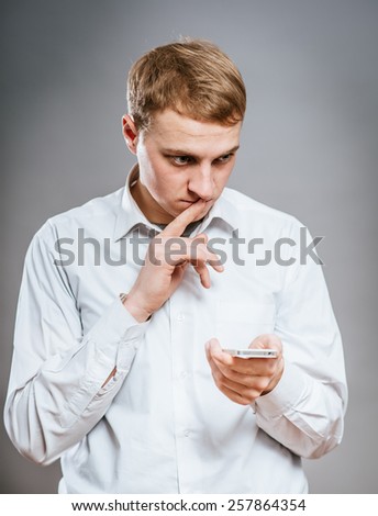 Bad news. Portrait of frustrated mature man in formalwear holding the mobile phone