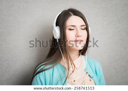 girl listening to music on the white headphones