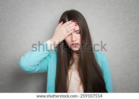Half-length portrait of woman touching her head. Concept of headache and high temperature