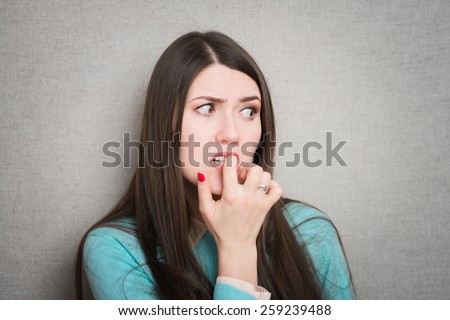 girl worries and bites his nails
