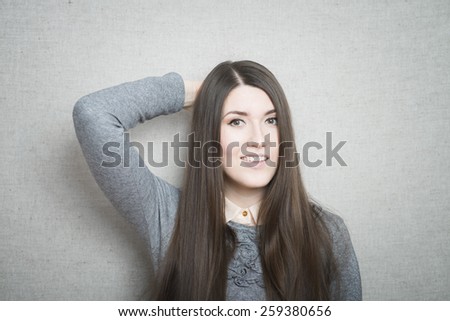 Portrait of a confused woman individual with hand in hair