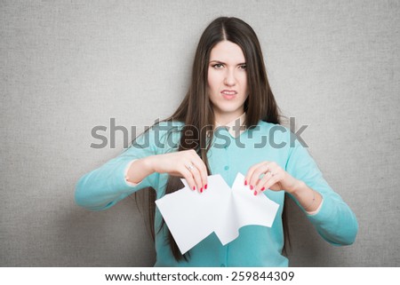 Breaking contract. Furious young woman tearing up paper