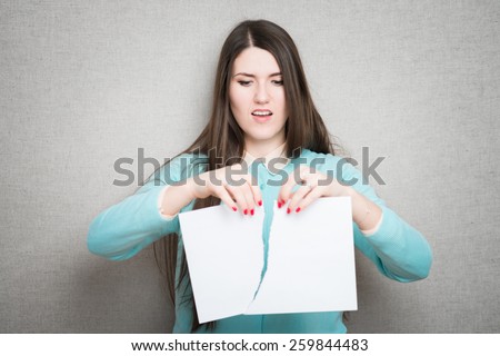 Confident business lady. Furious young woman tearing up paper