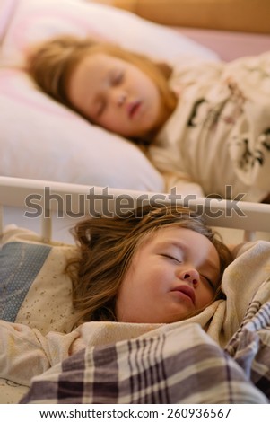 children sleeping girl in pajamas on the bed