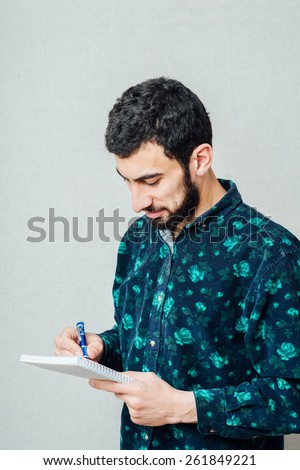 one guy note down something in his notebook