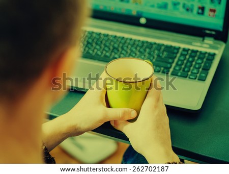 Cropped image of a young man working on his laptop in a coffee shop, rear view of business man hands busy using laptop at office desk, young male student typing on computer sitting at wooden table