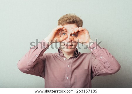 man making out of the hands glasses