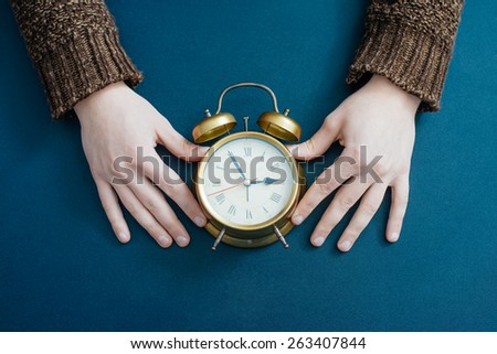 Alarm clock on businessman\'s hand, Time over concept