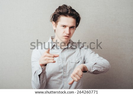 young man pointing to the clock on the invisible hand