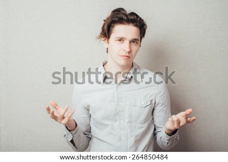 Young handsome man showing something