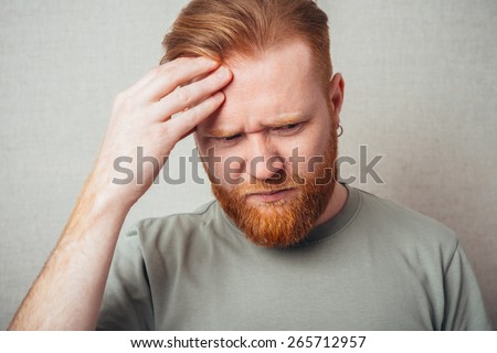 Young red bearded Man having a headache